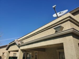 The back of a house with two scupper boxes and a seamless K-Style rain gutters going along of the house.