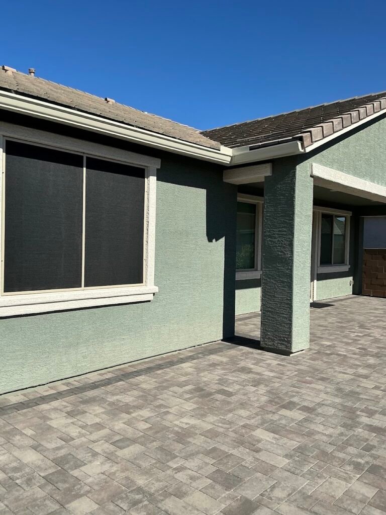 Seamless K-style rain gutters and custom window sun screens installed on a Phoenix-area home