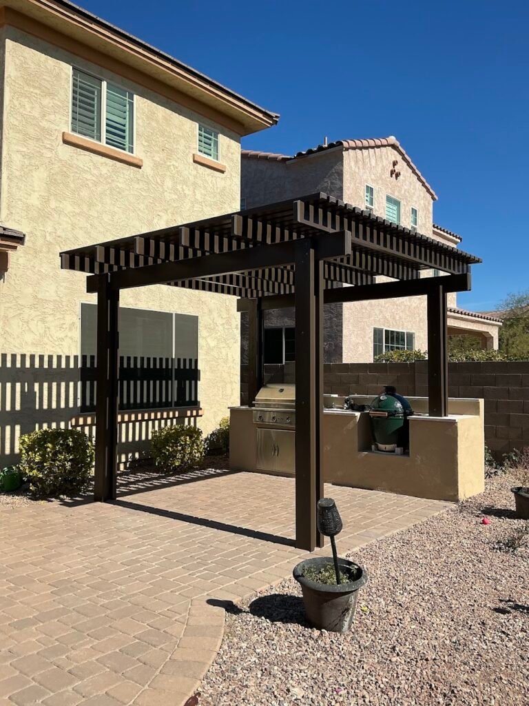 Freestanding aluminum lattice patio cover installed over a backyard barbecue in Phoenix, Arizona