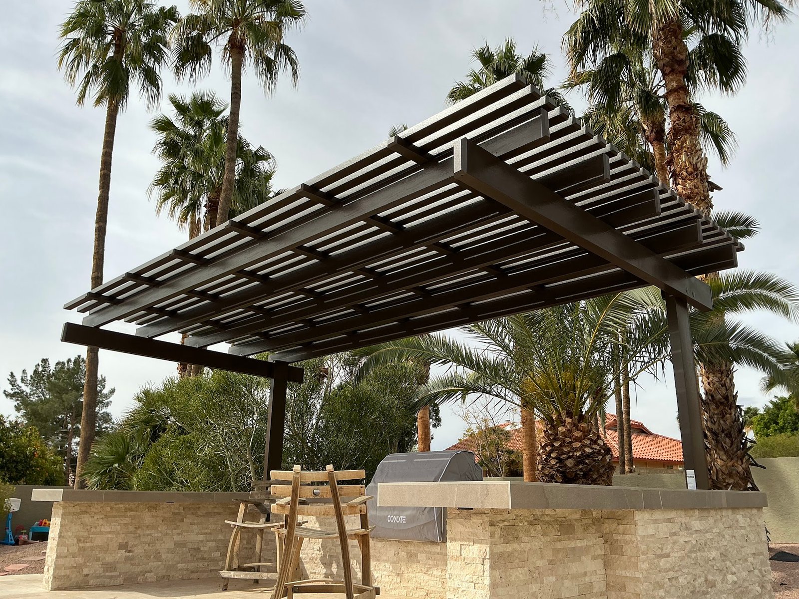 Custom aluminum lattice cantilever patio cover installed over an outdoor barbecue area in Phoenix, Arizona